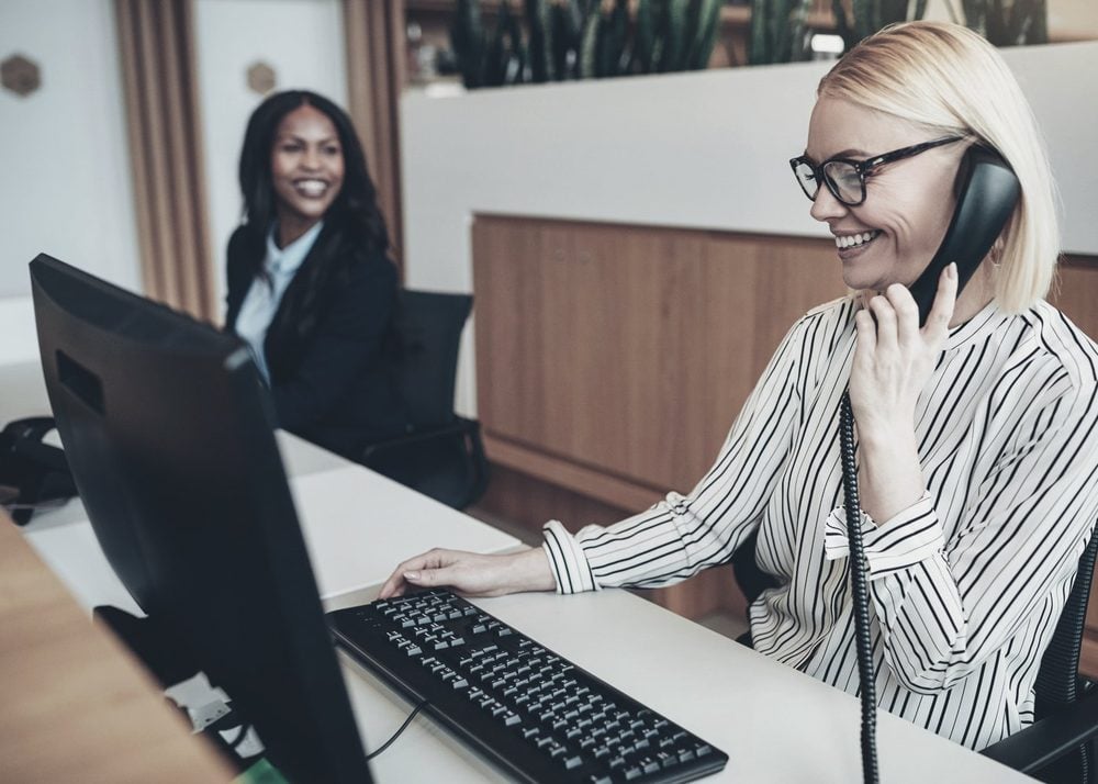 A receptionist taking a call for a client