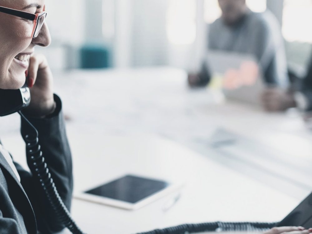 A business owner on the phone at her desk