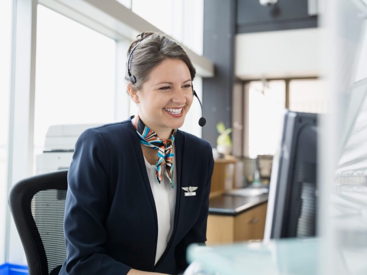 Receptionist with a headset answering after-hours calls at a computer