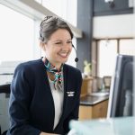 Receptionist with a headset answering after-hours calls at a computer