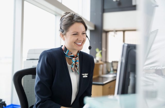 Receptionist with a headset answering after-hours calls at a computer